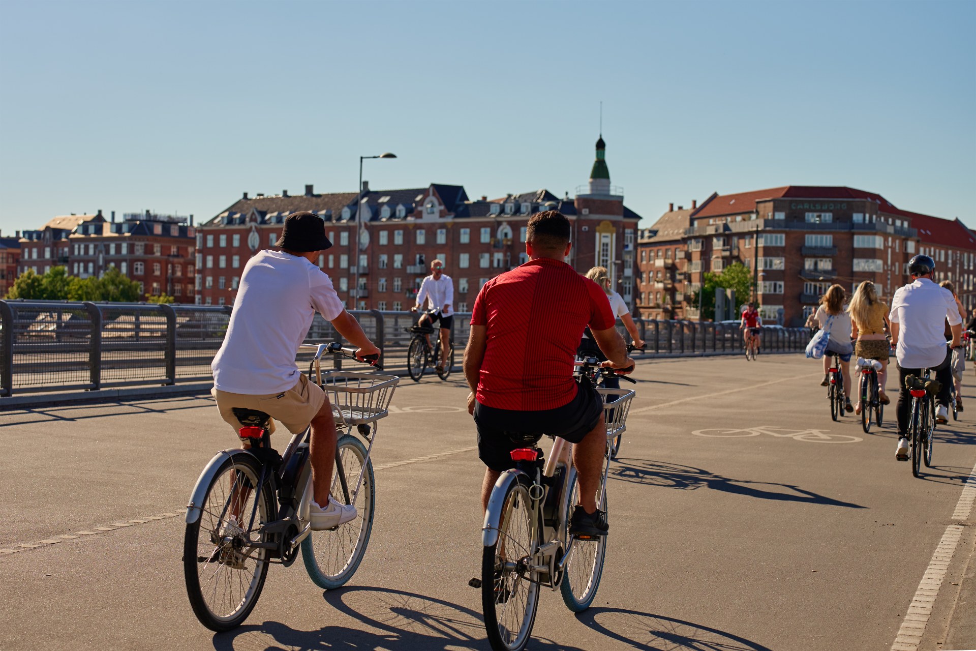 Junge Leute fahren mit dem Fahrrad durch eine Straße in Kopenhagen